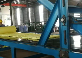 Blanket rolling and packing machine